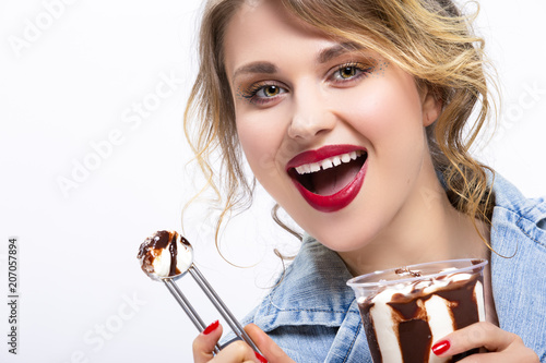 Healhy Food Ideas and Concepts. Closeup of Enticing Caucasian Blond Girl Eating Chocolate Icecream with Dessert Spoon. Posing Against White.