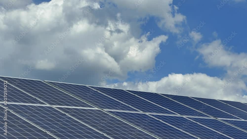 Solar panels on a solar station. The clouds are reflected on the surface of the solar panels. Alternative clean electricity. Polycrystalline and single crystal elements. Solar panels on a solar station. The clouds are reflected on the surface of the solar panels. Alternative clean electricity. Polycrystalline and single crystal elements.