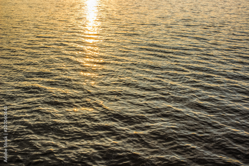 water surface in evening sunset time with soft yellow and orange colors and empty space for copy or text water surface in evening sunset time with soft yellow and orange colors and empty space for copy or text