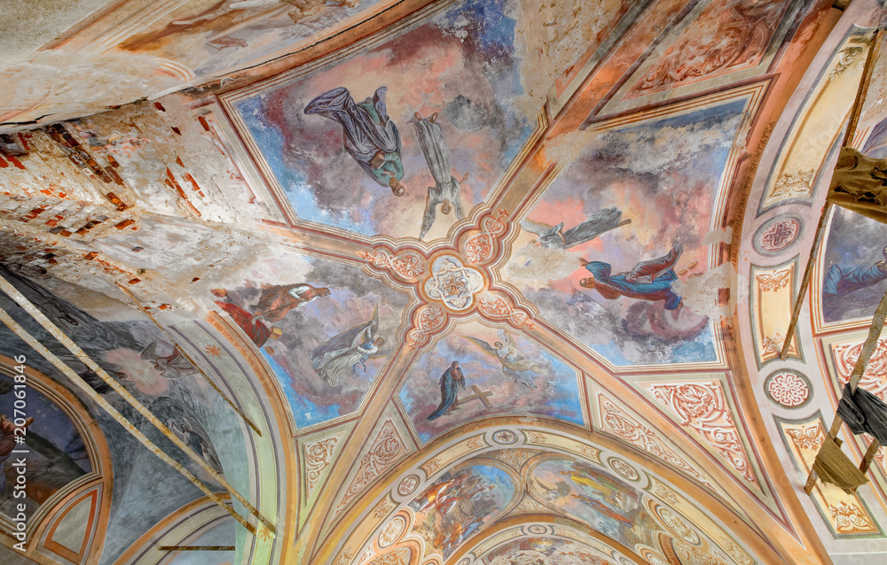 The ceiling with a painting on biblical themes in the abandoned brick Orthodox Church