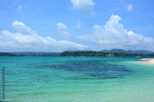 沖縄の青い空と白い雲とエメラルドグリーンのビーチ
