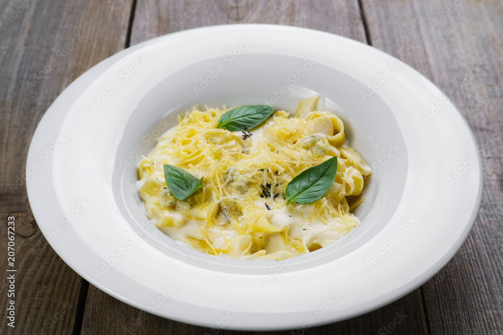 Pasta Fettuccine with blue cheese, bechamel sauce and parmesan. Healthy food, vegetarian meals. Traditional Italian cuisine Pasta Fettuccine with blue cheese, bechamel sauce and parmesan. Healthy food, vegetarian meals. Traditional Italian cuisine