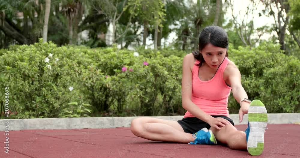 Sport woman do stretching on leg at outdoor park Sport woman do stretching on leg at outdoor park
