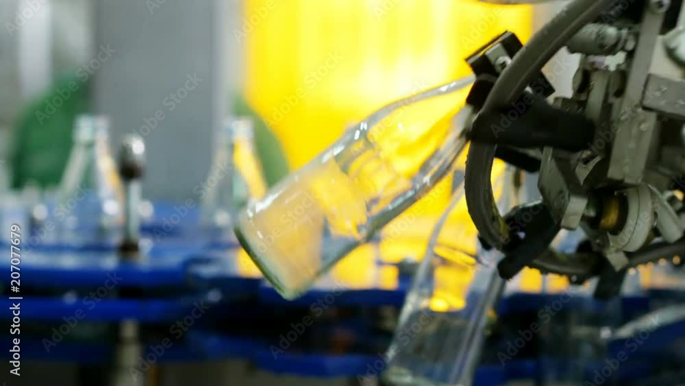 Automatic machine line for filling water in a glass bottle. Bottling of herbal drink in glass bottles. Production of drinking water and beverages. Automatic machine line for filling water in a glass bottle. Bottling of herbal drink in glass bottles. Production of drinking water and beverages.