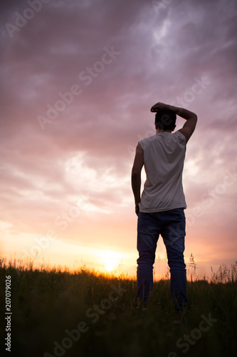 Silhouette of a man against a beautiful sunset sky © Evgenia Tiplyashina