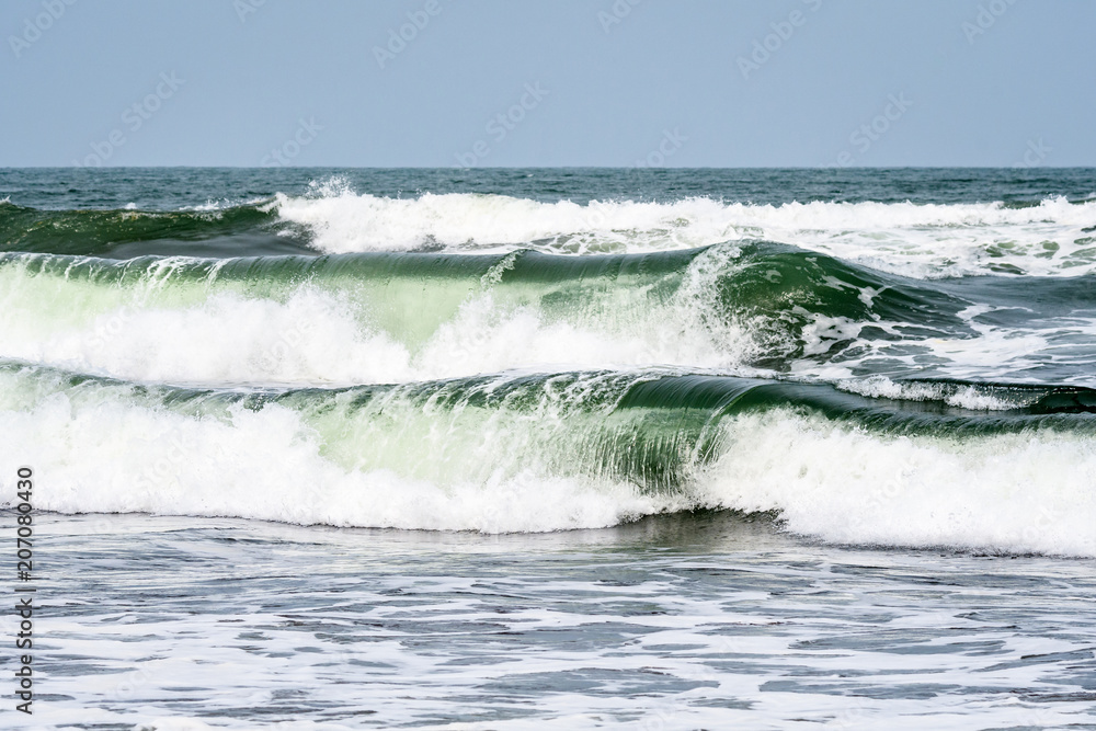 Waves breaking on the Caribbean Sea with blue sky in the background, as a nature background
