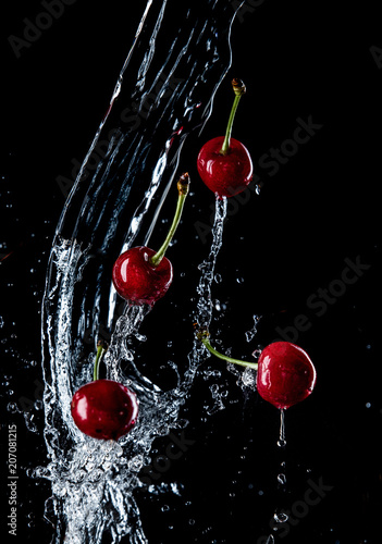 cherries in the spray of water, fresh fruits falling in water