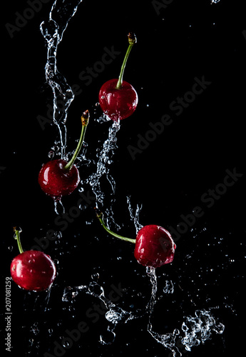 cherries in the spray of water, fresh fruits falling in water