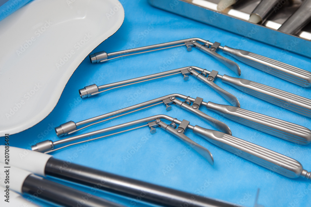 Ligators for the treatment of hemorrhoids made of stainless steel on blue medical tablecloths Ligators for the treatment of hemorrhoids made of stainless steel on blue medical tablecloths