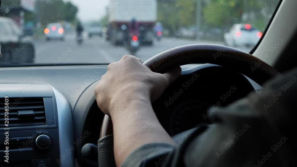 adult man hand chauffeur control steering wheel of car driving on road adult man hand chauffeur control steering wheel of car driving on road