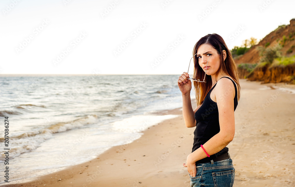 beautiful girl taking off glasses with herself, at sea beautiful girl taking off glasses with herself, at sea