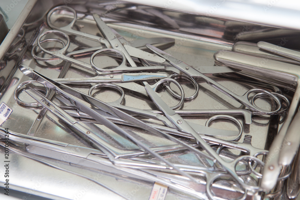 Medical scissors, tweezers and other tools in a stainless steel tray Medical scissors, tweezers and other tools in a stainless steel tray