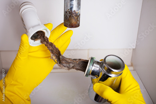 Washbasin's siphon cleaning in a bathroom photo