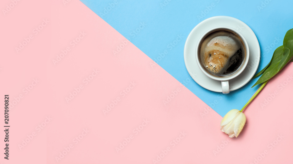 Flat lay of minimalistic picture of coffee and tulips on pink and yellow background. Minimalism coffee concept Flat lay of minimalistic picture of coffee and tulips on pink and yellow background. Minimalism coffee concept
