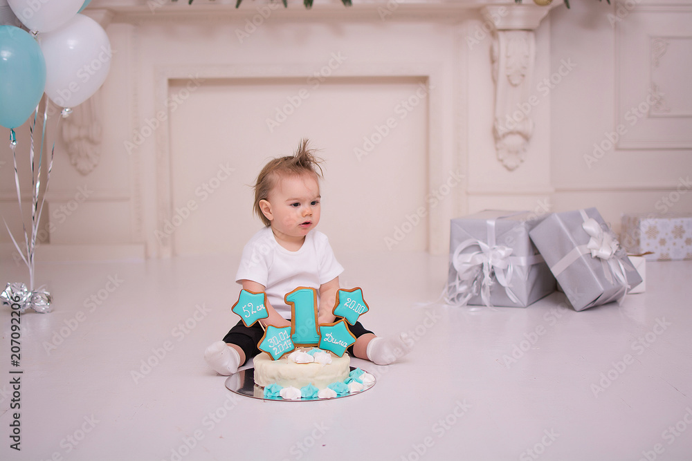 The baby is eating the first birthday cake