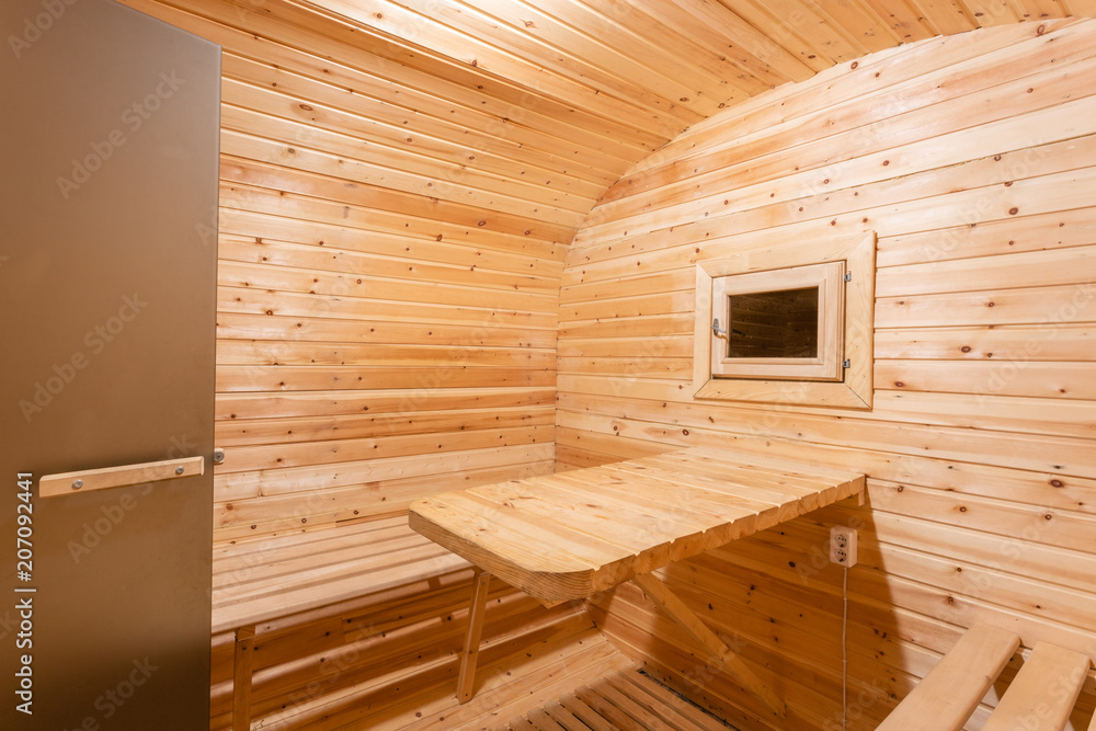 interior of sauna. rural mobile wooden bath in the form of a barrel in a pine forest interior of sauna. rural mobile wooden bath in the form of a barrel in a pine forest