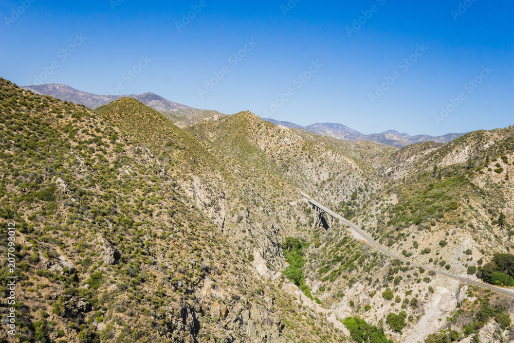 Bridge across deep span in the desert mountains of Los Angeles County's National Forest.