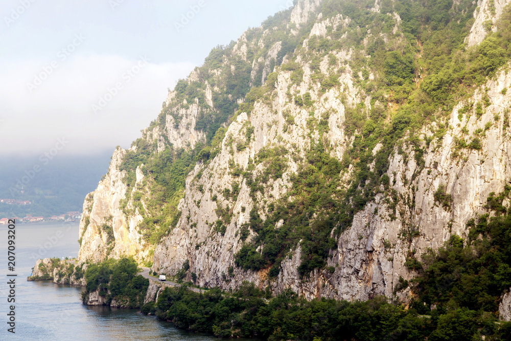 Summer landscape of Danube Gorge, at the border between Romania and Serbia. Mountain road on the Danube coast Summer landscape of Danube Gorge, at the border between Romania and Serbia. Mountain road on the Danube coast