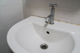 old vintage tap with ceramic washbasin in bathroom