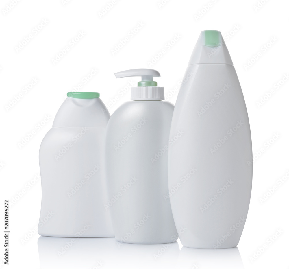 Blank white mockup dispenser and plastic bottles of cosmetic products with green lids Blank white mockup dispenser and plastic bottles of cosmetic products with green lids