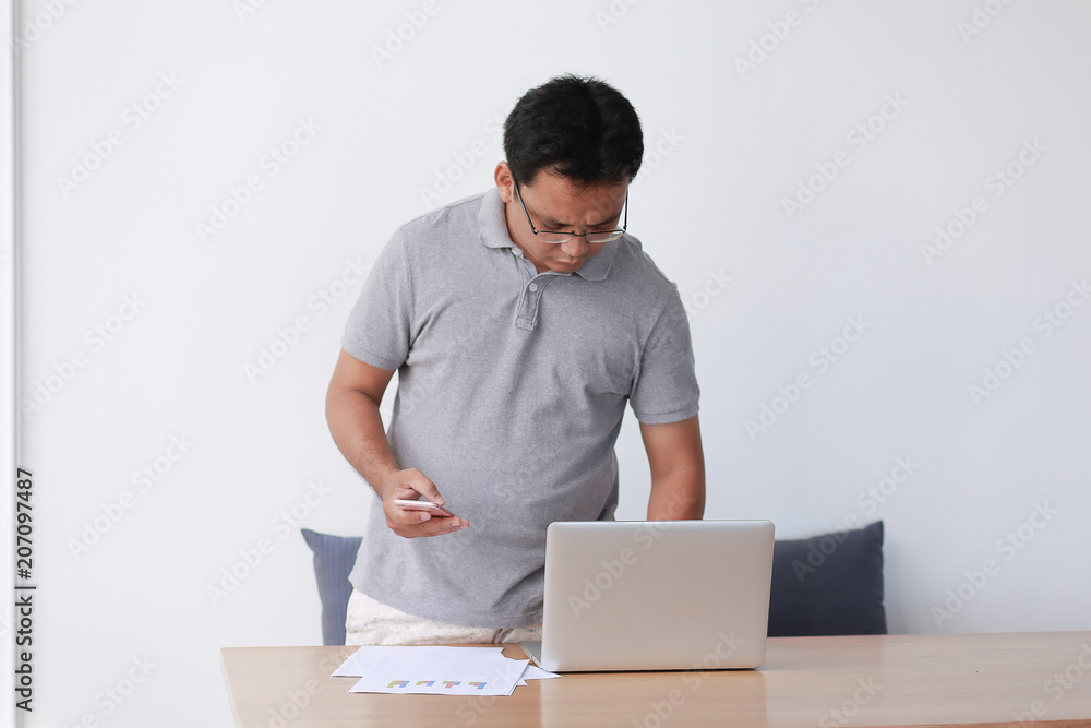 Handsome businessman is working with laptop in office Online Handsome businessman is working with laptop in office Online