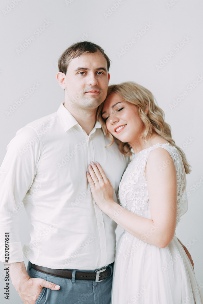 Beautiful couple in wedding photo shoot. Loft Studio in European style, bright and with large Windows. Loving people with happy faces. Bridal bouquet and stylish decorative. Beautiful couple in wedding photo shoot. Loft Studio in European style, bright and with large Windows. Loving people with happy faces. Bridal bouquet and stylish decorative.