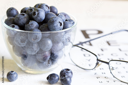 Bilberry cure for eyes concept with glasses Fototapeta