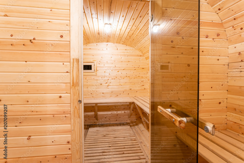 interior of sauna. rural mobile wooden bath in the form of a barrel in a pine forest