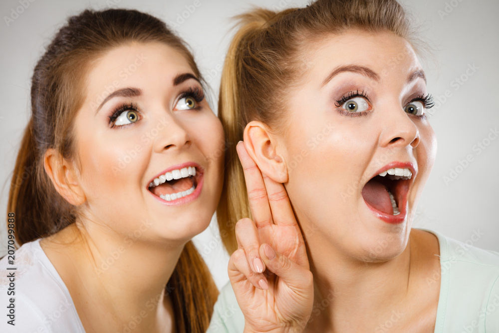 Two women telling gossip Two women telling gossip