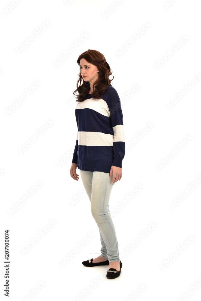full length portrait of girl wearing striped blue and white jumper and jeans. standing pose on white studio background full length portrait of girl wearing striped blue and white jumper and jeans. standing pose on white studio background