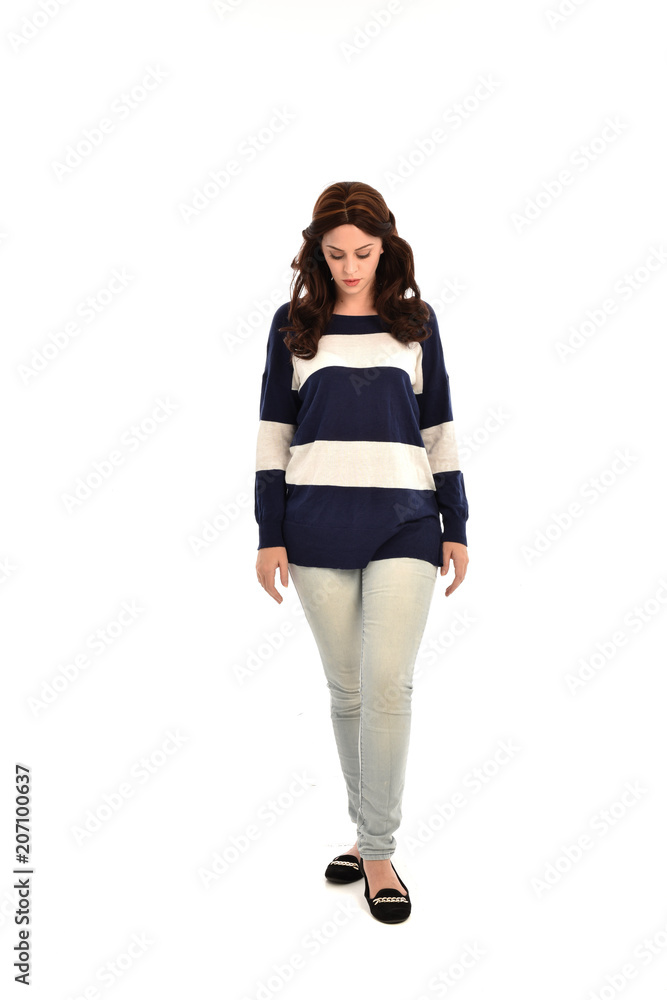full length portrait of girl wearing striped blue and white jumper and jeans. standing pose on white studio background full length portrait of girl wearing striped blue and white jumper and jeans. standing pose on white studio background