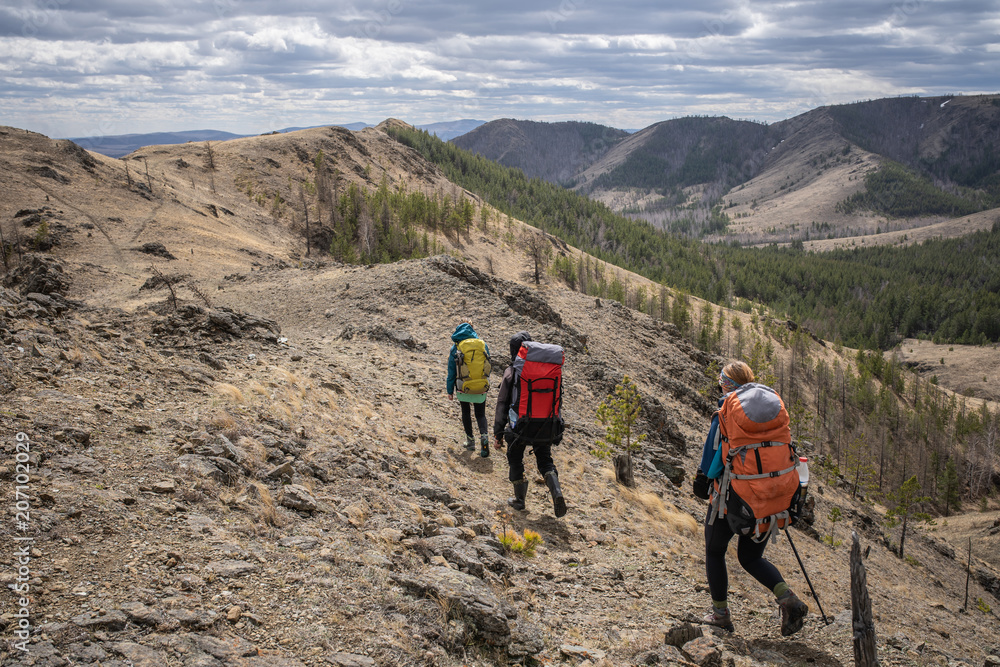 Group of three hikers on trail. Group of three hikers on trail.