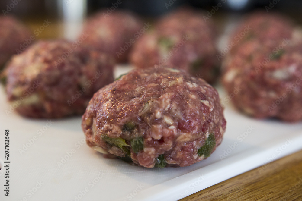Making meatballs in a kitchen Making meatballs in a kitchen