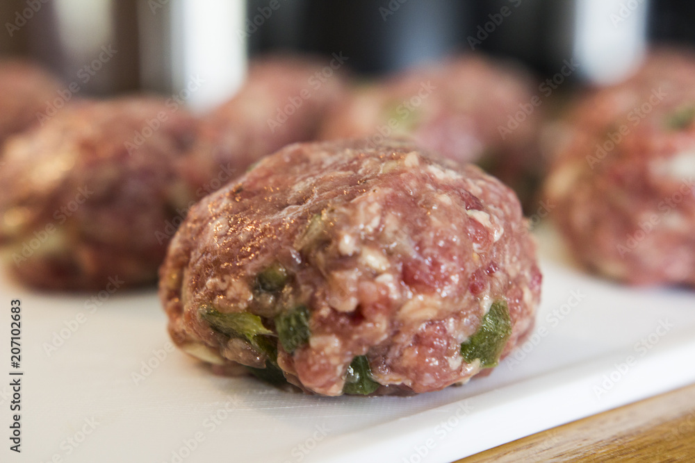 Making meatballs in a kitchen Making meatballs in a kitchen
