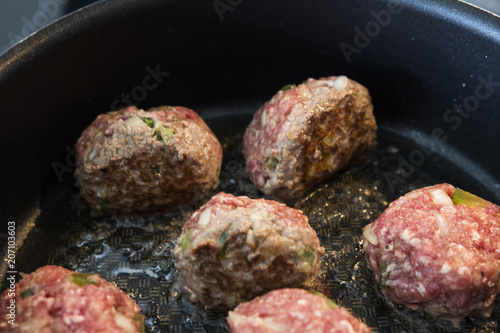 Making meatballs in a kitchen 