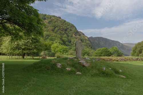 Celtic cross, grave hill, against beautiful mountain range, tranquil peaceful scene