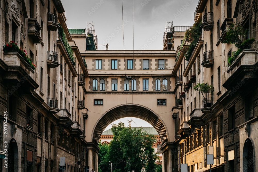Traditional Milanese buildings with an impressive arch on Via Tommaso Salvini in Milan's Porta Venezia district, Lombardy, Italy
