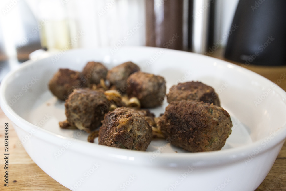 Making meatballs in a kitchen Making meatballs in a kitchen