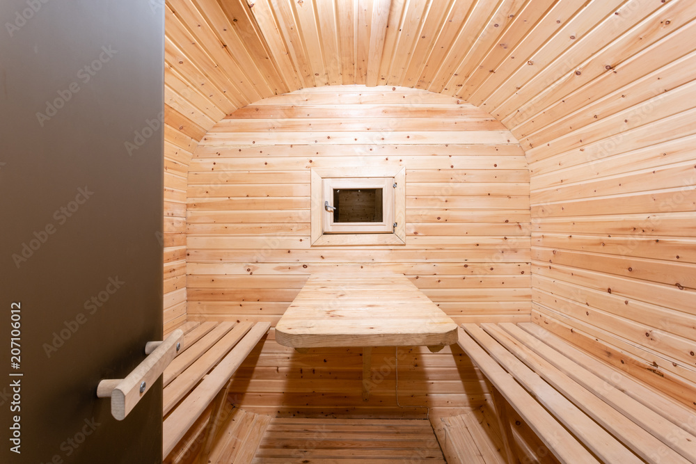 interior of sauna. rural mobile wooden bath in the form of a barrel in a pine forest interior of sauna. rural mobile wooden bath in the form of a barrel in a pine forest