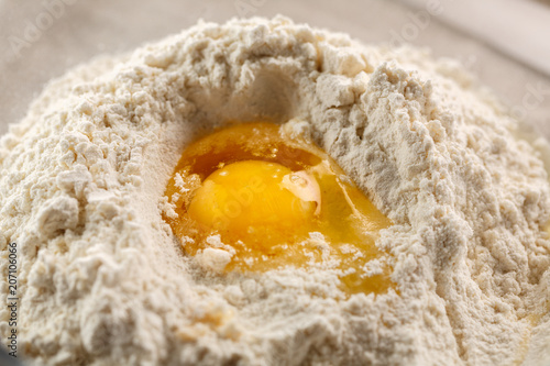 broken egg in flour. Preparation of yeast dough