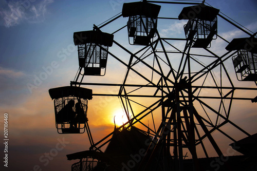 Silhouette Of Lover In The Ferris Wheel In The Evening. © rakop_ton
