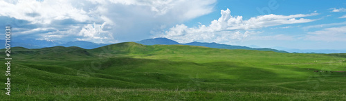 Panoramic view of beautiful green hills on sunny day