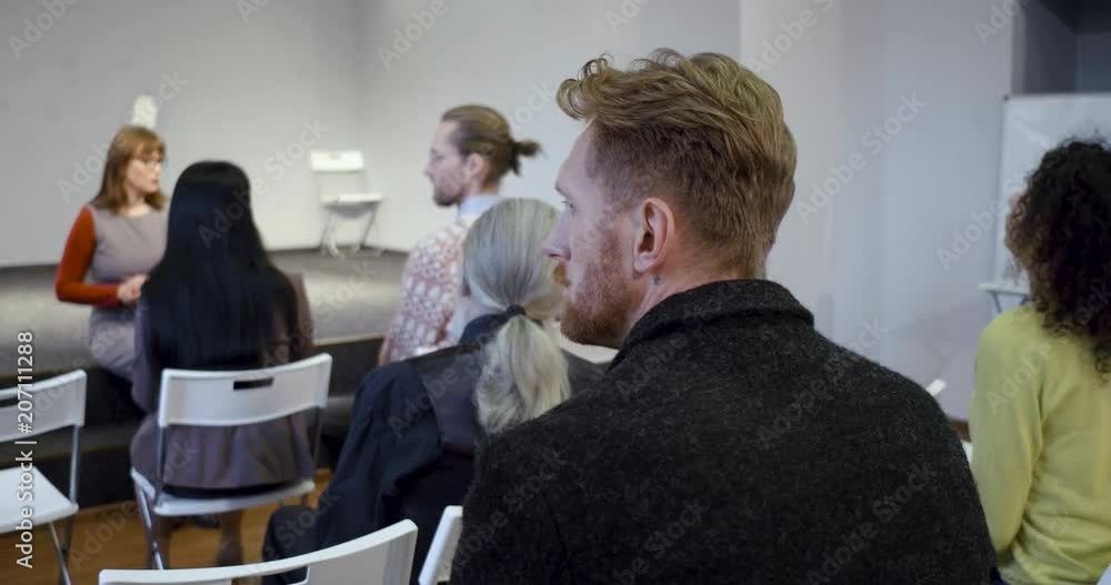 Members of addicted group meeting sitting in audience and listening to coach. Support concept. Members of addicted group meeting sitting in audience and listening to coach. Support concept.