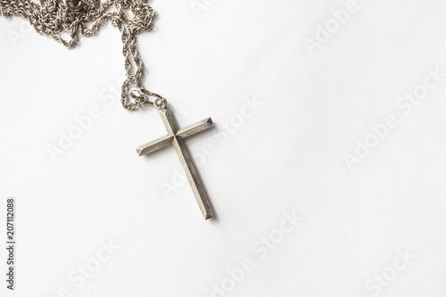 Silver cross with chain on white background