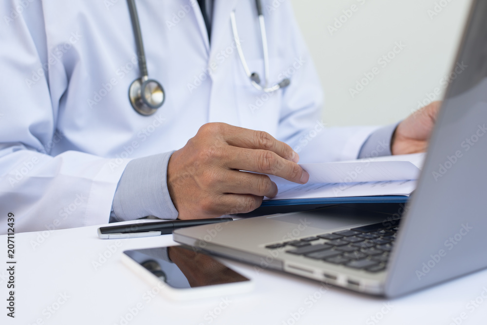 Doctor working on laptop computer Doctor working on laptop computer