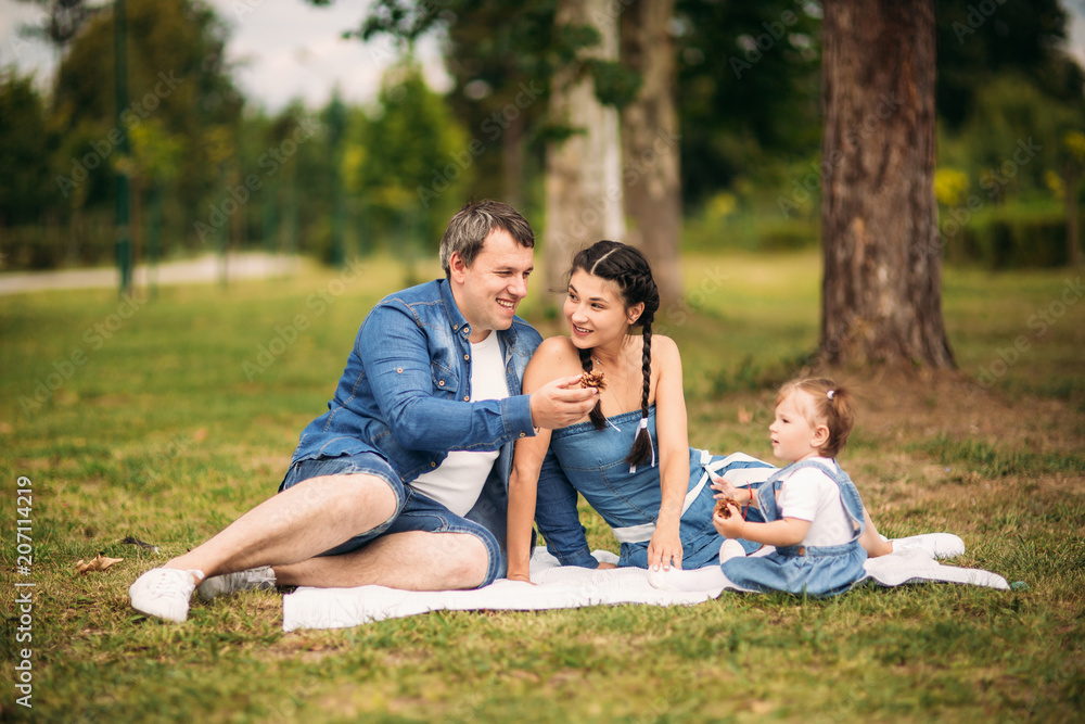 happy young family spending time outdoor on a summer day