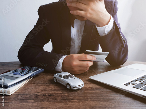 Businessman are concerned about paying a car installment by credit card..