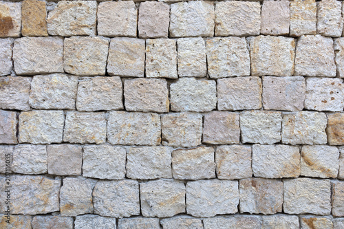 Texture of a stone wall from a large cobblestone shell closeup