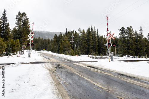 Fotografie Railroad Crossing in a Winter Mountain Landscape on a Snowy Day