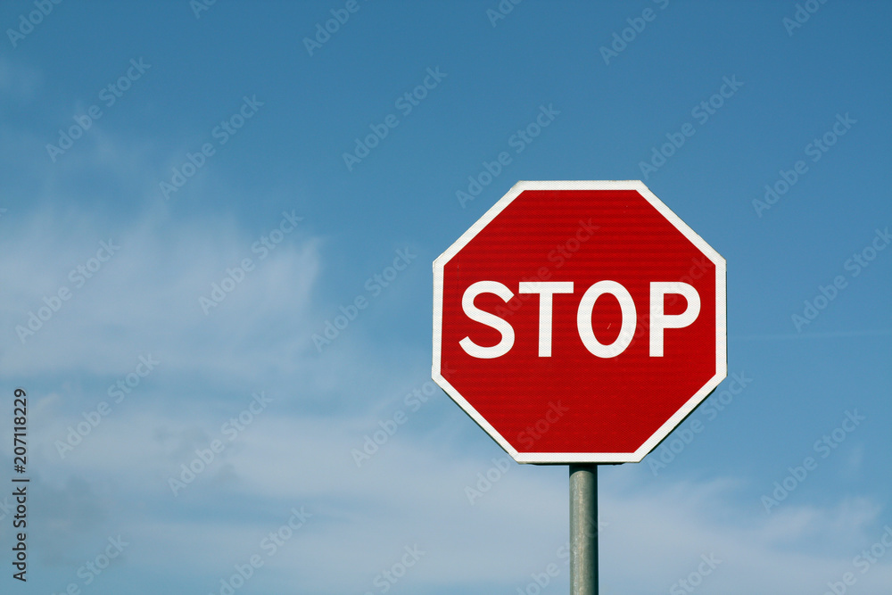 Stop sign against cloudy sky.